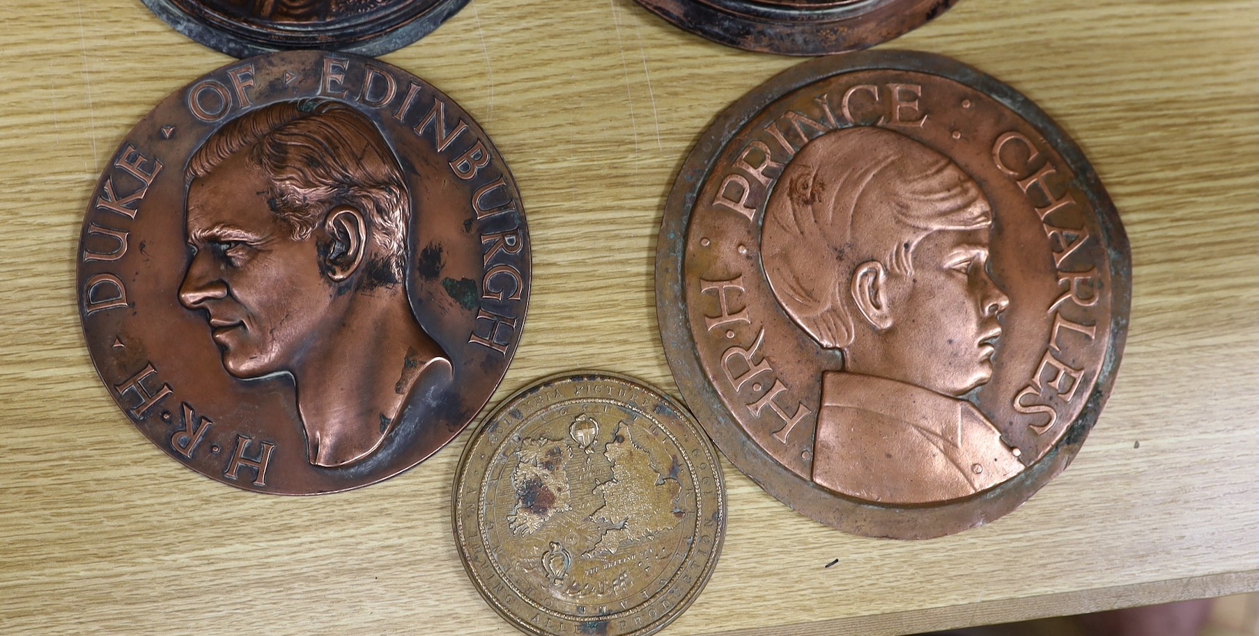 A group of six various cast copper or bronze medallion roundels. Largest 28cm diameter